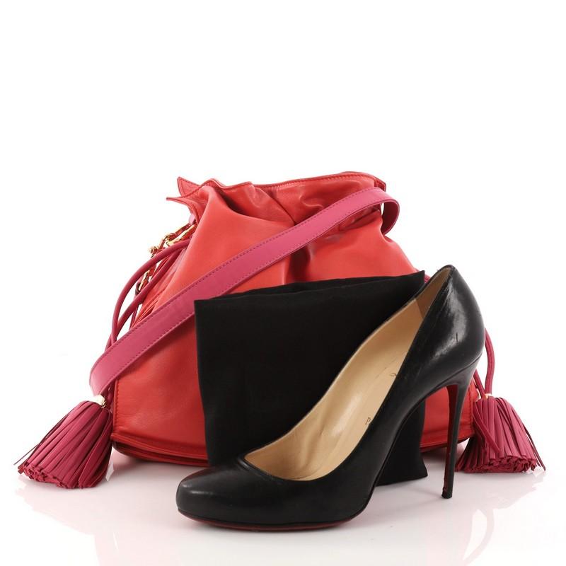 This authentic Loewe Flamenco Bag Leather Medium is simply a must-have for your wardrobe. Crafted in red leather, this classy stylish bag features leather shoulder strap, drawstring top with oversized tassels, and gold-tone hardware accents. Its