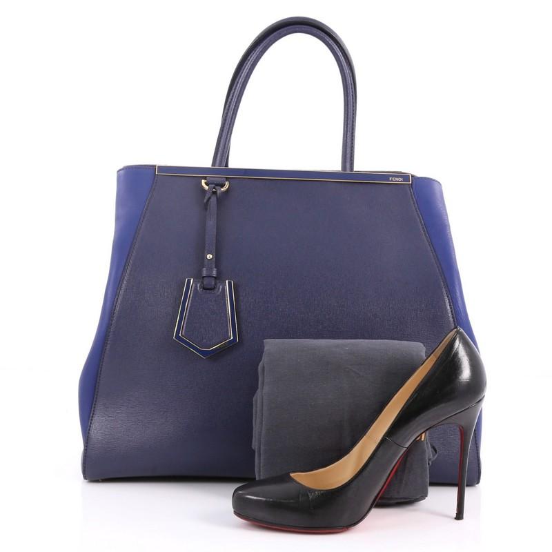 This authentic Fendi 2Jours Handbag Leather Large is an impeccably stylish bag perfect for your everyday looks. Crafted in blue leather with smooth side wings, this popular tote features dual-rolled leather handles, accented with a shining top bar