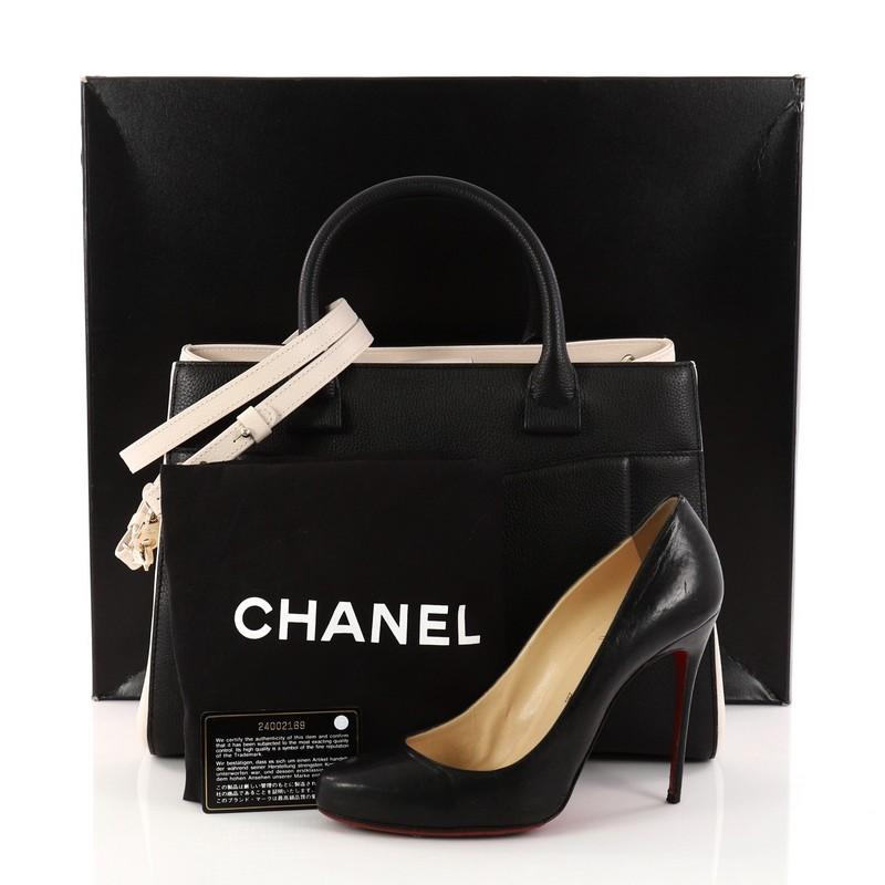 This authentic Chanel Neo Executive Tote Grained Calfskin Small is the ideal everyday accessory for the modern woman. Crafted from beautiful black and off-white grained calfskin leather, this functional tote features dual-rolled leather handles,