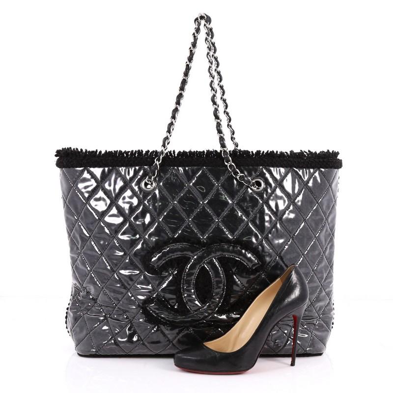This authentic Chanel Funny Tweed Tote Quilted Vinyl Large is a chic and playful piece to add to any collection. Crafted from black quilted vinyl with frayed tweed edges, this fabulous bag features dual woven-in vinyl chain straps, large embroidered