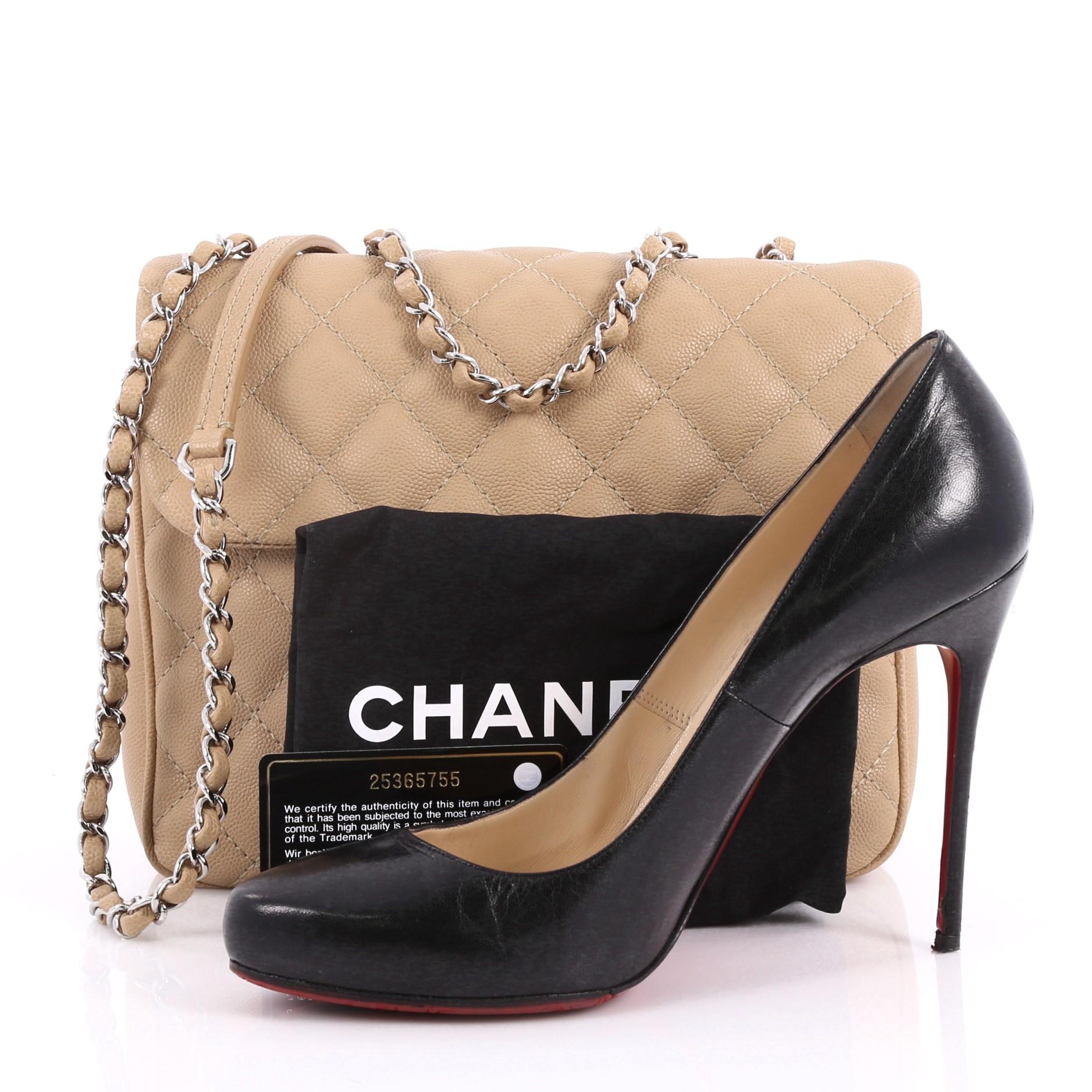 This authentic Chanel Urban Companion Flap Bag Quilted Caviar Small is a fabulous bag. Crafted in tan quilted caviar leather, this chic bag features woven-in leather chain strap with leather pad, front flap with CC-turn-lock closure, exterior back