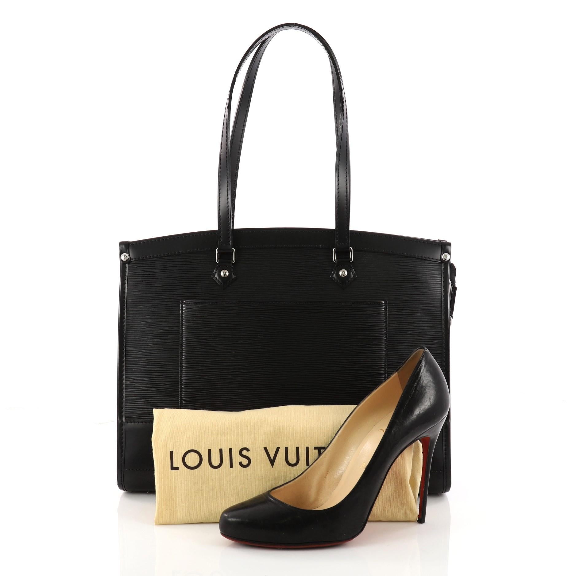 This authentic Louis Vuitton Madeleine Handbag Epi Leather GM named after the Parisian church, Place de la Madeleine is a perfectly elegant bag for day or night out. Crafted from black epi leather, this chic tote features dual-flat leather handles,
