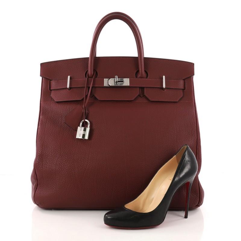 This authentic Hermes Birkin HAC Handbag Rouge H Fjord with Palladium Hardware 40 exudes traditional Hermes luxury. Crafted in Rouge H fjord leather, this hard-to-find Birkin HAC features dual-rolled leather handles, palladium hardware, frontal flap