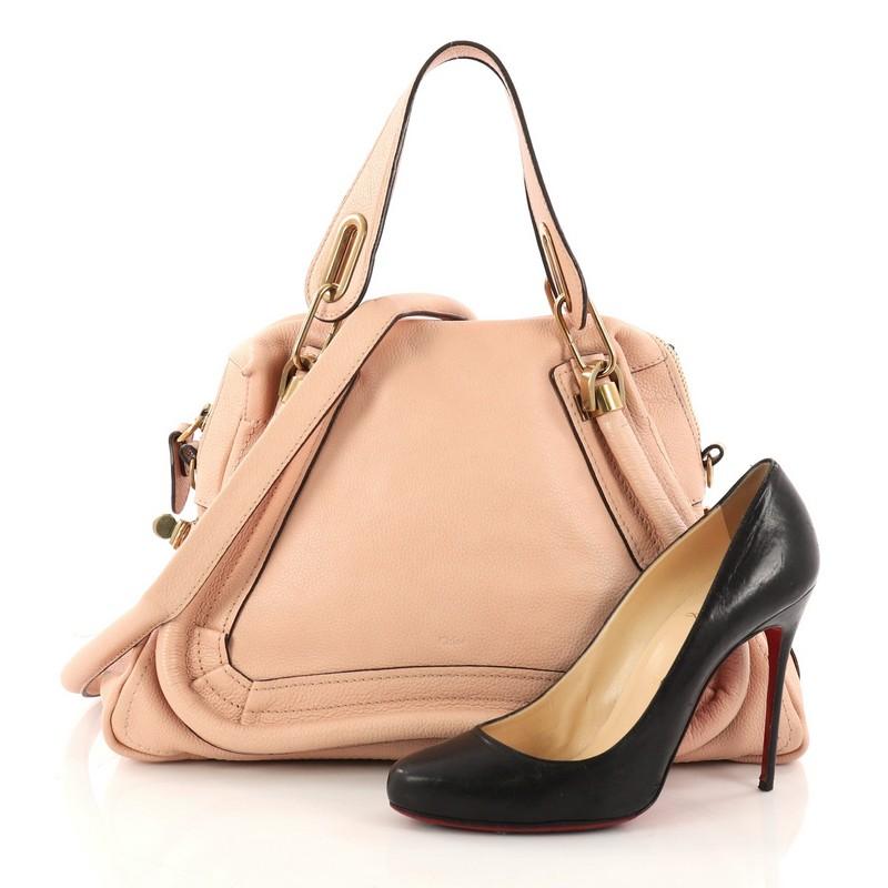 This authentic Chloe Paraty Top Handle Bag Leather Medium mixes style and functionality perfect for the modern woman. Crafted from pink leather, this versatile satchel features piped trim details, dual handles, side twist locks, and gold-tone