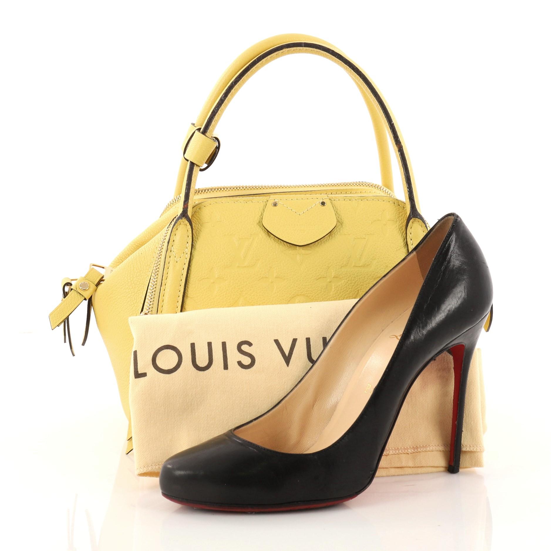This authentic Louis Vuitton Marais Handbag Monogram Empreinte Leather BB is a re-styling of the classic bowling bag that show casual and chic style made perfect for everyday life. Crafted from yellow monogram empreinte leather, this bowler features