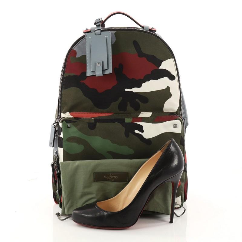 This authentic Valentino Camouflage Backpack Nylon and Leather Large is a stylish backpack perfect for on-the go moments. Crafted in camouflage nylon, this practical bag features dual shoulder straps, stud detailing, exterior front zip pocket and