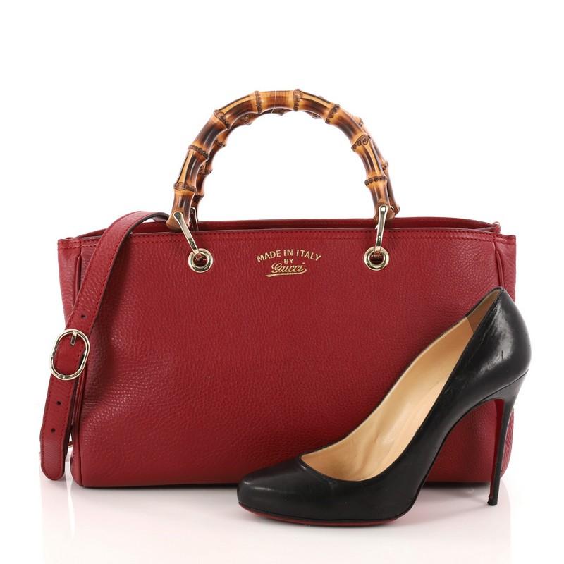 This authentic Gucci Bamboo Shopper Tote Leather Medium is a classic must-have. Crafted from red leather, this simple yet stylish tote features Gucci's signature sturdy bamboo handles, protective base studs, stamped logo at the front, and bamboo and