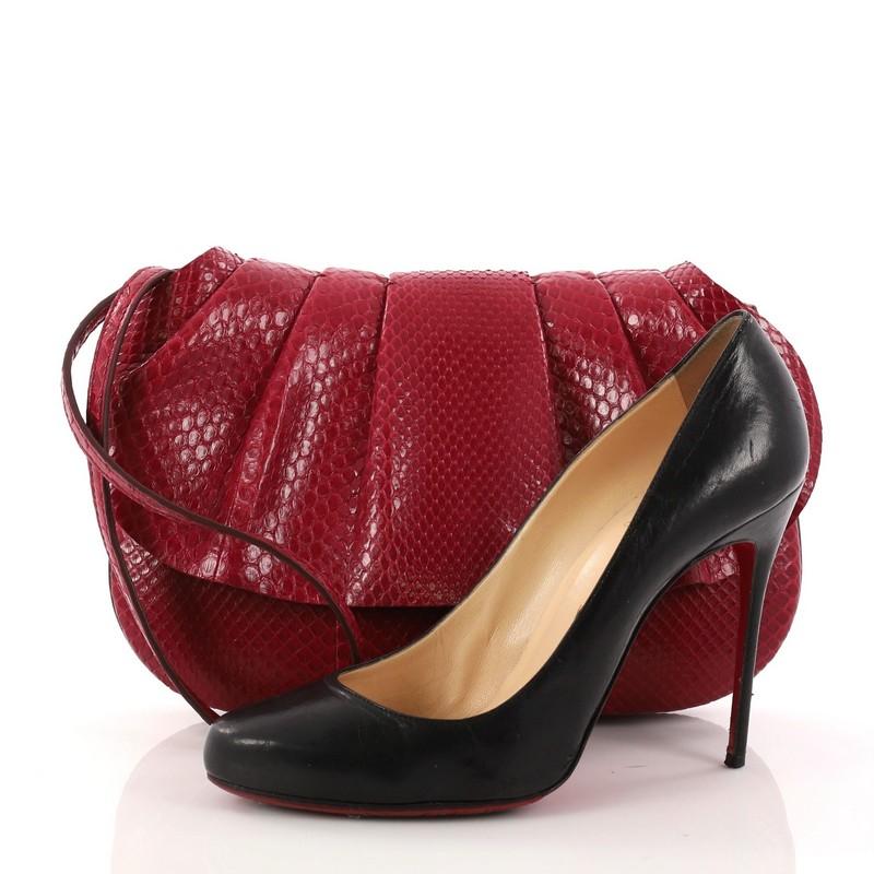 This authentic The Row Fan Shoulder Bag Python 10 is a chic bag designed to resemble a fan and showcases the label's signature minimalist style. Crafted in genuine red python skin this bag features a ruffled front flap, detachable strap, and