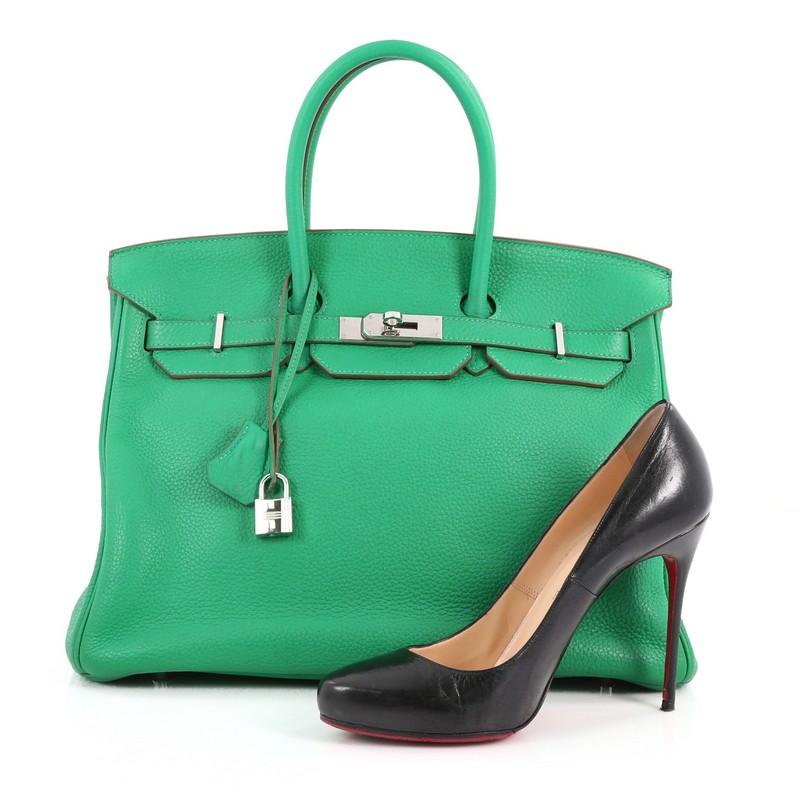 This authentic Hermes Birkin Handbag Menthe Clemence with Palladium Hardware 35 stands as one of the most-coveted and timeless bags fit for any fashionista. Constructed from scratch-resistant Menthe Clemence leather, this bag features dual-rolled