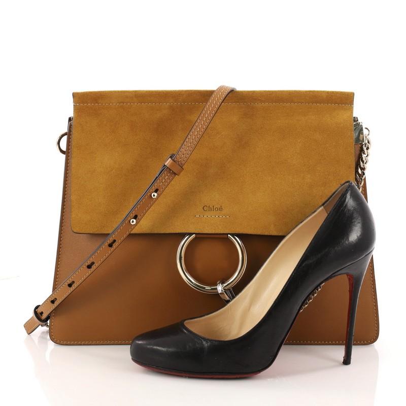 This authentic Chloe Faye Shoulder Bag Leather and Suede Medium personify Chloe's unique luxe bohemian aesthetic with an ode to the 70's. Crafted in mustard leather and suede, this sleek bag features a ring with chain, gusseted sides, stamped logo