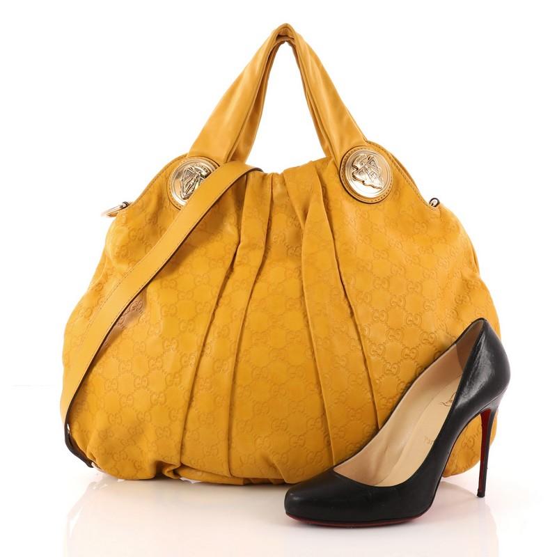 This authentic Gucci Hysteria Convertible Top Handle Bag Guccissima Leather Large is a lovely accessory showcasing an easy-casual yet elegant design. Crafted from mustard embossed guccissima leather, this luxurious tote showcases dual shoulder
