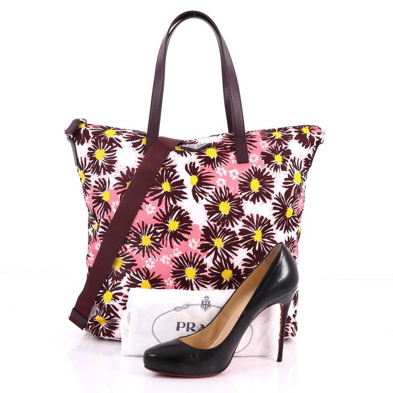 This authentic Prada Convertible Tote Printed Tessuto With Saffiano Large is an eye-catching piece perfect for modern fashionistas. Crafted from maroon and pink printed tessuto with maroon Saffiano leather, this tote features a stunning floral print