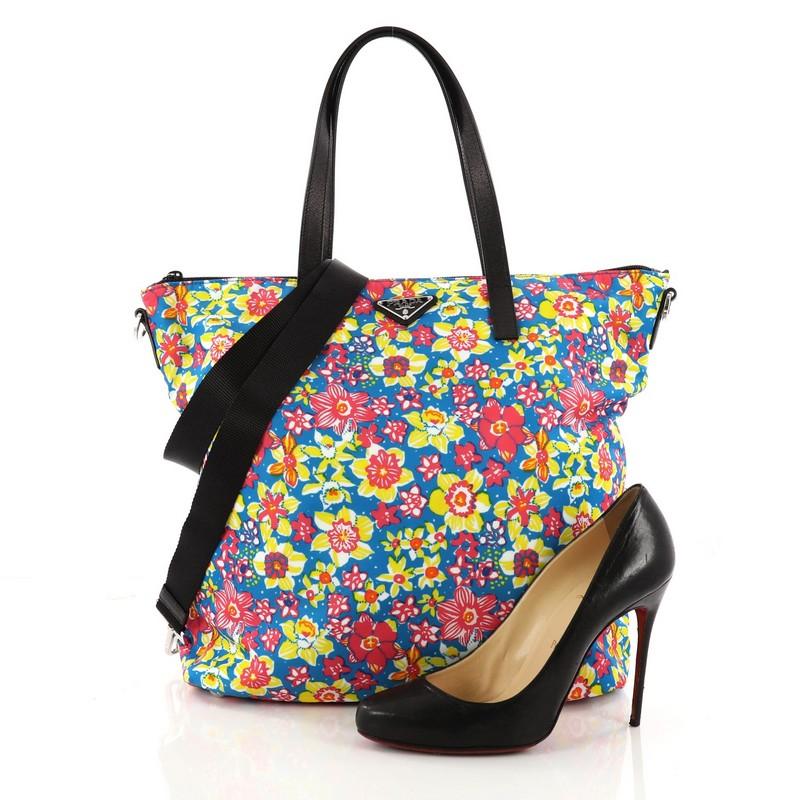 This authentic Prada Convertible Tote Printed Tessuto With Saffiano Large is an eye-catching piece perfect for modern fashionistas. Crafted from multicolor printed tessuto with black saffiano leather, this tote features a stunning floral print