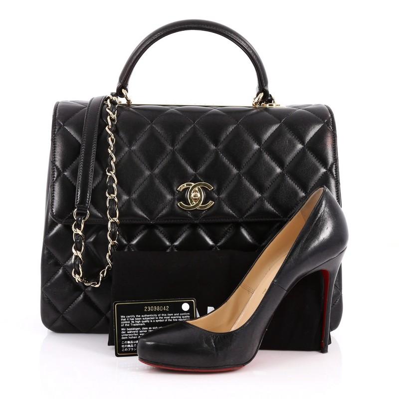 This authentic Chanel Trendy CC Top Handle Bag Quilted Lambskin Large is a marvelous day or evening bag. Crafted from black quilted lambskin leather, this chic bag features flat leather top handle, woven-in leather chain strap with leather pad,