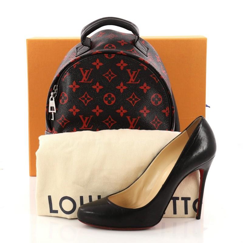 This authentic Louis Vuitton Palm Springs Backpack Limited Edition Monogram Infrarouge PM is a standout made for care-free urban fashionistas. Crafted from black and red monogram infrarouge coated canvas, this cult-favorite backpack features padded