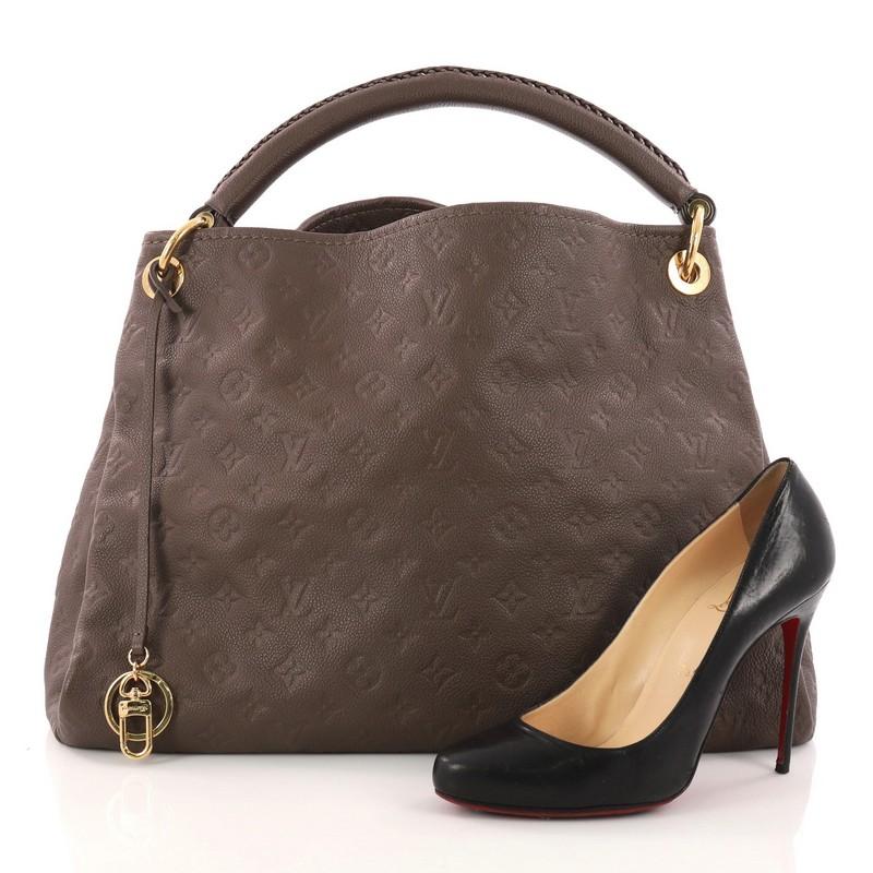 This authentic Louis Vuitton Artsy Handbag Monogram Empreinte Leather MM is an iconic hobo. Crafted from taupe monogram embossed empreinte leather, this luxurious and refined hobo features a single looped braided top handle with polished gold links,
