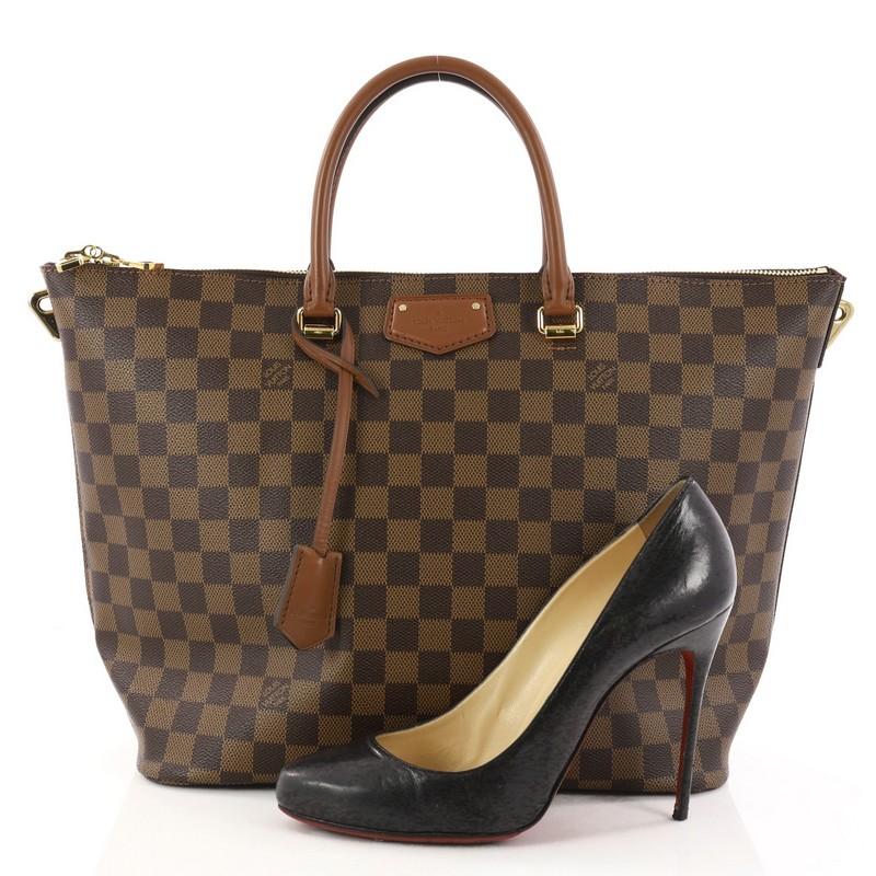 This authentic Louis Vuitton Belmont Handbag Damier is both stylish and versatile made for everyday excursions. Crafted from damier ebene coated canvas with brown leather trims, this heritage-inspired structured tote features dual-rolled leather