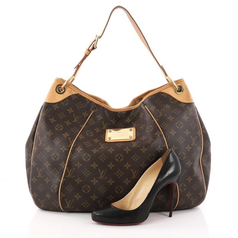 This authentic Louis Vuitton Galliera Handbag Monogram Canvas GM is a fashionable everyday accessory that is as practical as it is iconic. Crafted from Louis Vuitton's signature monogram coated canvas, this shoulder bag features cowhide leather