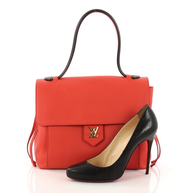 This authentic Louis Vuitton Lockme Handbag Leather PM is a must-have signature satchel made for the modern woman. Crafted in red leather, this sophisticated yet feminine bag features a long leather top handle, side leather laces that cinch the bag,