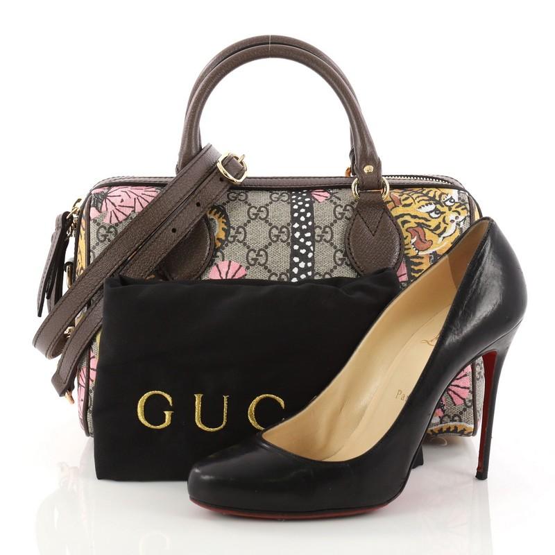 This authentic Gucci Boston Bag Bengal Print GG Coated Canvas Small is uniquely designed for everyday use. Crafted from brown GG supreme coated canvas, this stylish bag features multicolor Bengal motif print throughout exterior, dual-rolled leather