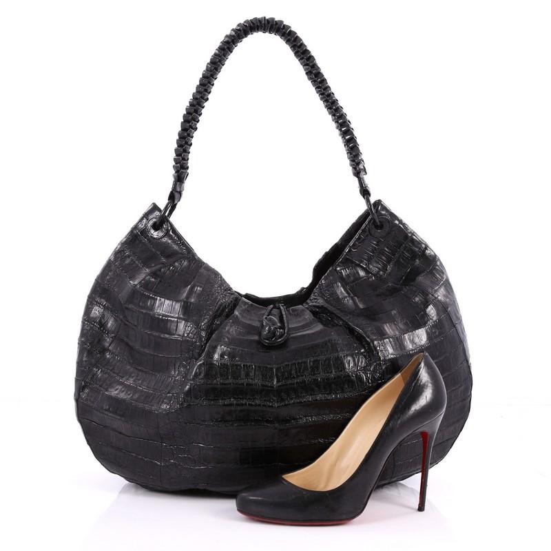 This authentic Nancy Gonzalez Braided Handle Hobo Pleated Crocodile Large is a luxurious bag perfect for the modern fashionista. Crafted from genuine black crocodile skin, this bag features a braided shoulder strap, pleated detailing, and gold-tone