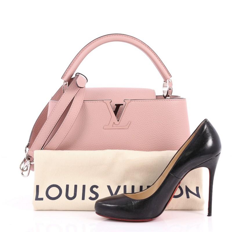 This authentic Louis Vuitton Capucines Handbag Leather PM is sophisticated and ladylike luxurious bag inspired by its Parisian heritage. Crafted from pink taurillon leather, this chic bag features a single loop leather handle secured by jewel-like