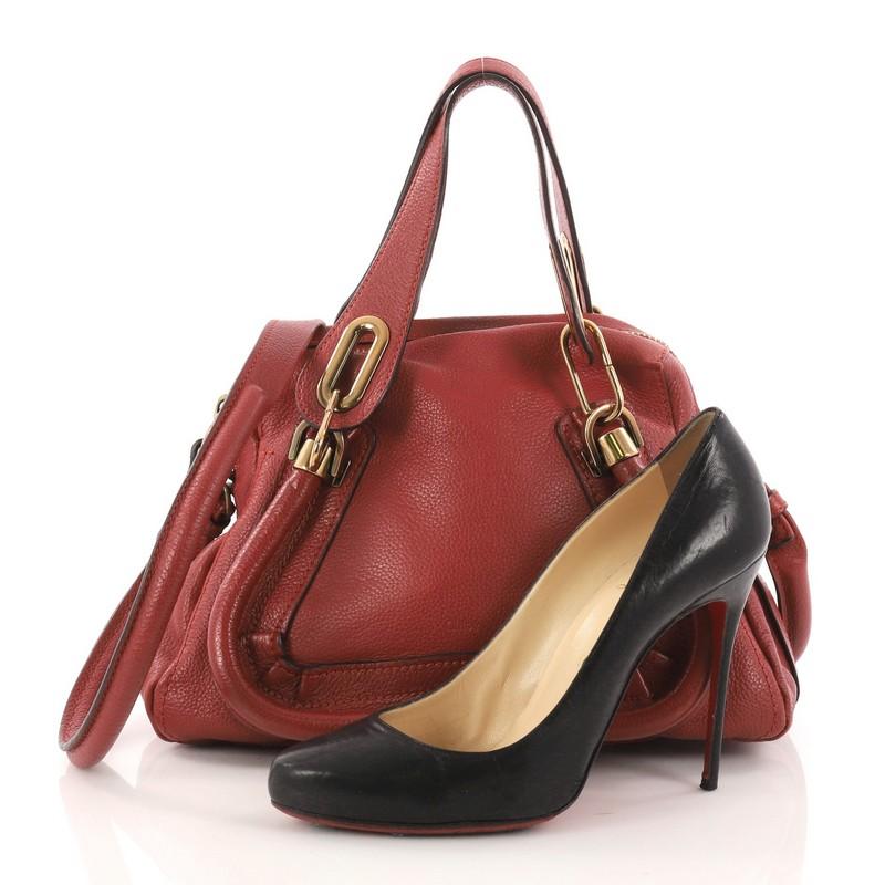 This authentic Chloe Paraty Top Handle Bag Leather Small mixes everyday style and functionality perfect for the modern woman. Crafted from red leather, this versatile bag features dual flat handles, piped trim details, side twist locks, and