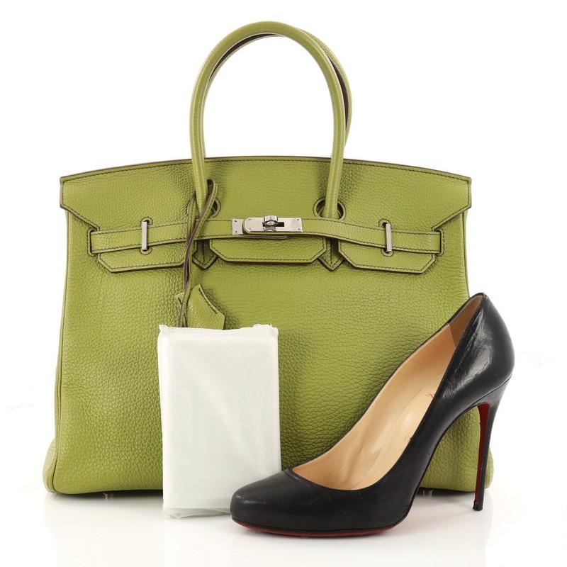 This authentic Hermes Birkin Handbag Vert Anis Togo with Palladium Hardware 35 stands as one of the most-coveted and timeless bags fit for any fashionista. Constructed from scratch-resistant Vert Anis Togo leather, this bag features dual-rolled top