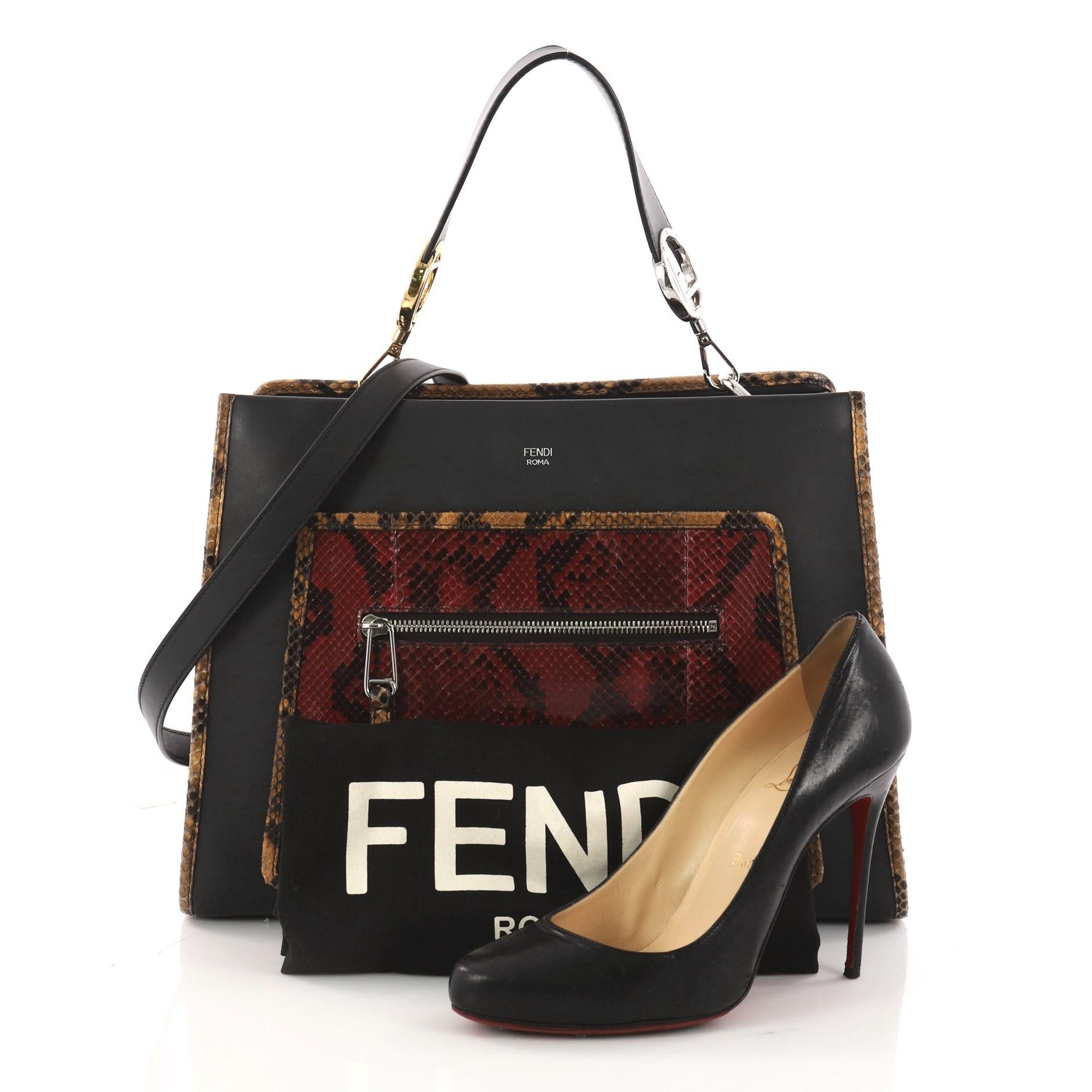 This authentic Fendi Runaway Handbag Leather and Python Medium is chic and stylish bag with a rigid structure. Crafted in black leather and genuine red python skin, this handbag features a removable flat top handle embellished with the new Fendi