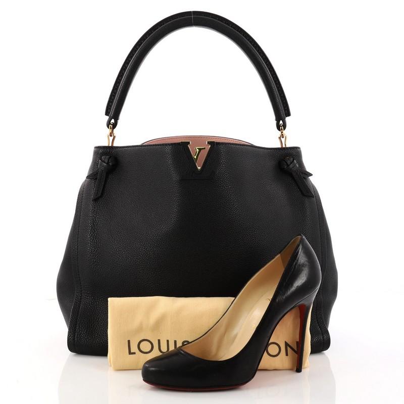 This authentic Louis Vuitton Tournon Handbag Leather is a chic and sophisticated hobo that is sure to be a must-have for any Louis Vuitton or fashion lover alike. Crafted in black taurillon leather, this bag features single rolled leather top