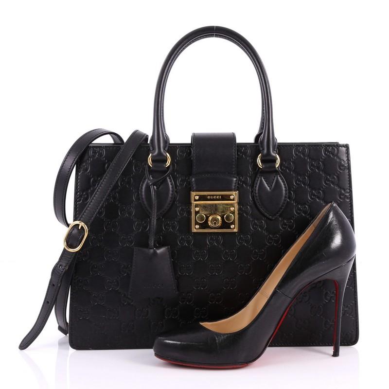 This authentic Gucci Padlock Convertible Tote Guccissima Leather Medium is a classic for Gucci lovers. Crafted in black guccissima leather, this tote features dual-rolled leather handles, structured silohette and gold-tone hardware accents. Its