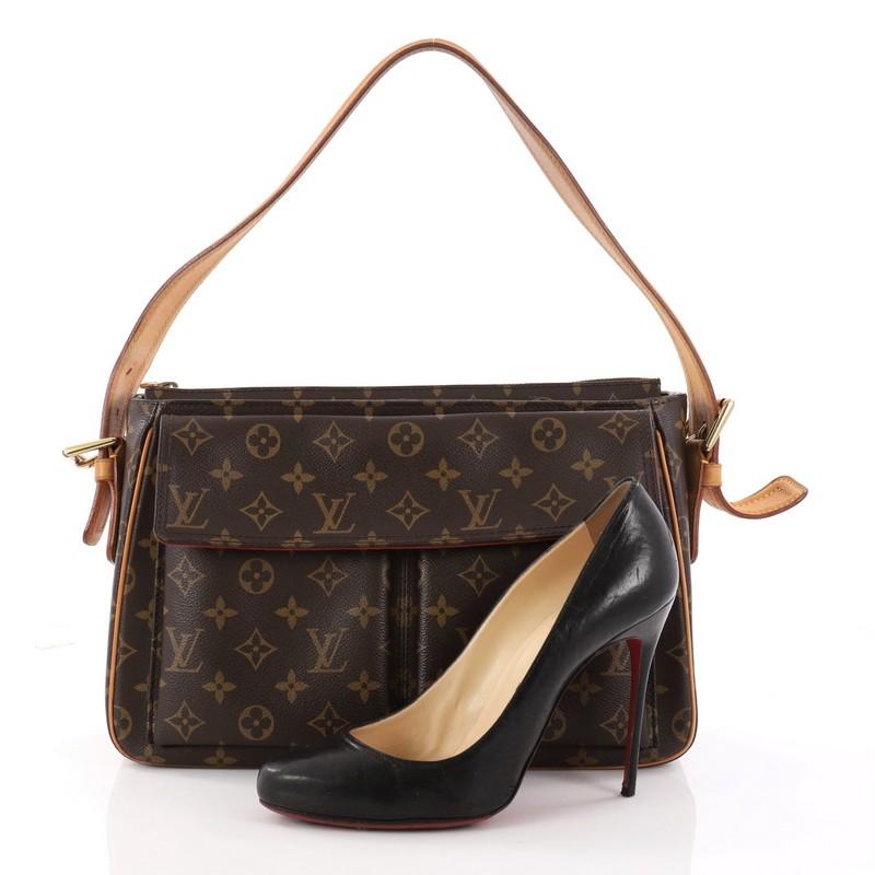 This authentic Louis Vuitton Viva Cite Handbag Monogram Canvas GM showcases a simple design made for everyday use. Crafted from Louis Vuitton's iconic brown monogram coated canvas, this bag features flat vachetta leather handle with buckle details,