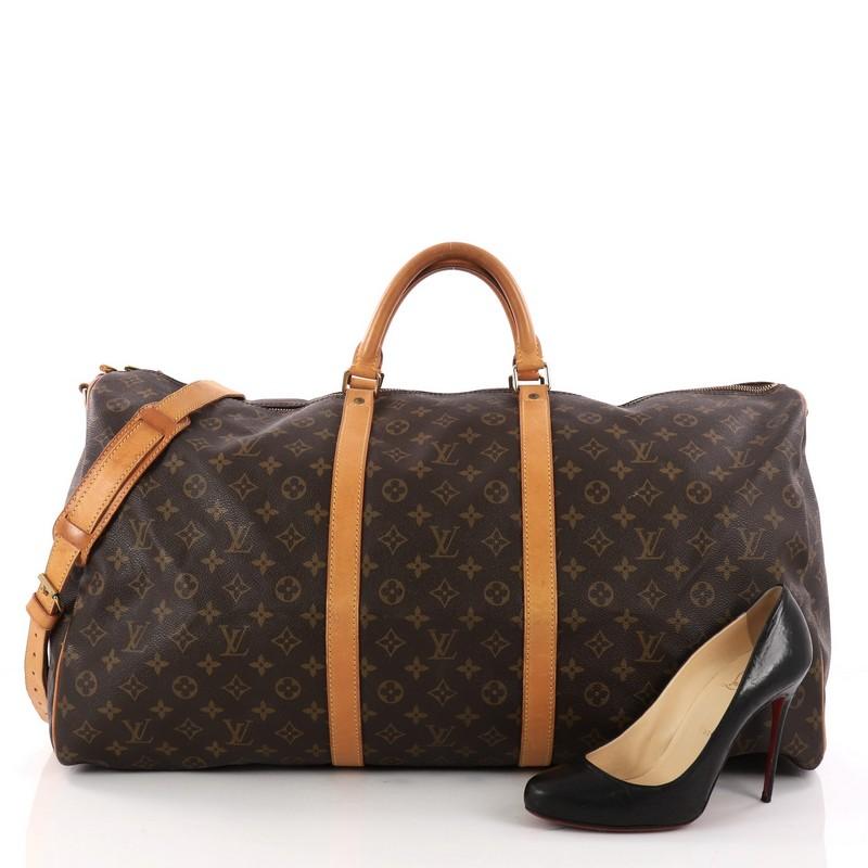 This authentic Louis Vuitton Keepall Bandouliere Bag Monogram Canvas 60 is the perfect purchase for a weekend trip, and can be effortlessly paired with any outfit from casual to formal. Crafted with traditional Louis Vuitton brown monogram coated