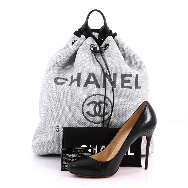 This authentic Chanel Deauville Backpack Canvas Large is an excellent backpack, perfect for everyday use and all your essentials. Crafted in light grey canvas, this lovely backpack features a rolled top handle, leather shoulder straps, Chanel logo