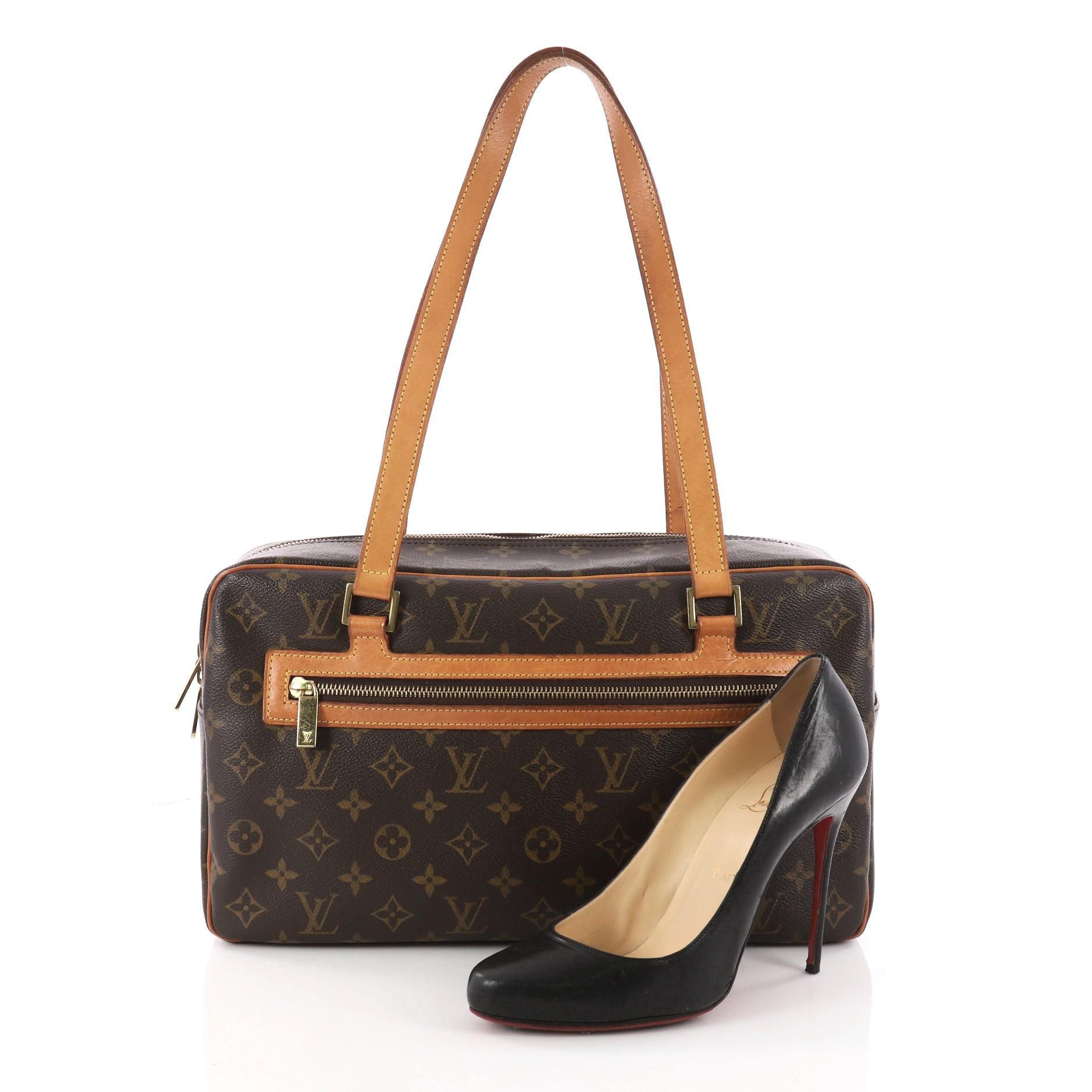 This authentic Louis Vuitton Cite Handbag Monogram Canvas GM showcases a simple design made for everyday use. Crafted from brown monogram coated canvas, this bag features dual flat cowhide shoulder strap, vachetta leather trims, exterior zip pocket,