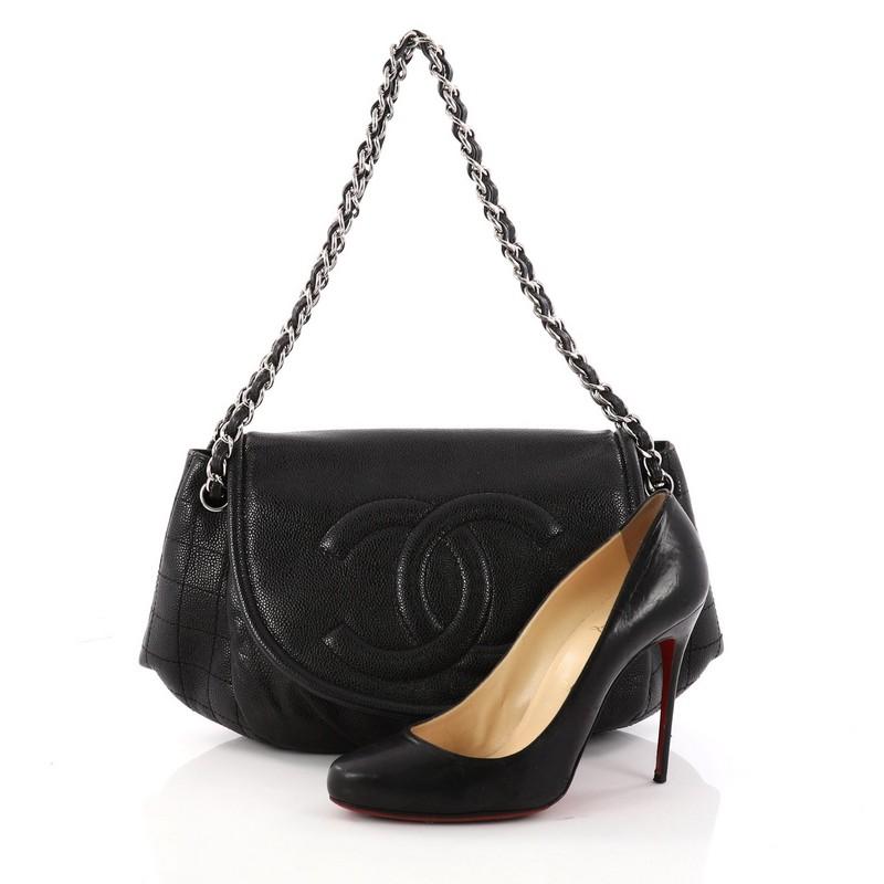 This authentic Chanel Timeless Half Moon Flap Bag Caviar Medium is a sophisticated and tasteful piece that can be carried fromday to night. Crafted from black caviar leather, this pleated flap bag features signature woven-in leather chain straps,
