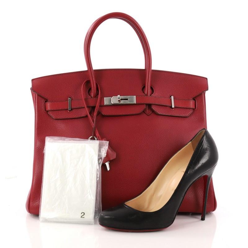 This authentic Hermes Birkin Handbag Rouge Red Buffalo Skipper with Palladium Hardware 35 stands as one of the most-coveted bags fit for any fashionista. Constructed from sturdy, scratch-resistant rouge red buffalo skipper leather, this stand-out