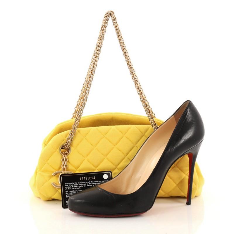 This authentic Chanel Just Mademoiselle Handbag Quilted Jersey Small showcases a sleek style that complements any look. Crafted from sumptuous yellow jersey in iconic diamond quilting pattern, this bag features reissue chains, a feminine