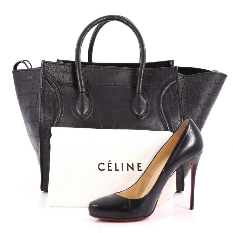 This authentic Celine Phantom Handbag Crocodile Embossed Leather Medium is one of the most sought-after bags beloved by fashionistas. Crafted from black crocodile embossed leather, this minimalist tote features dual-rolled handles, an exterior front