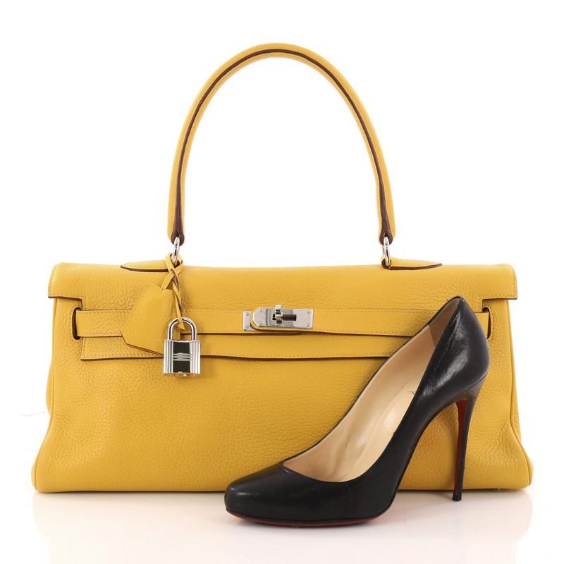 This authentic Hermes Shoulder Kelly Handbag Clemence 42 is a rare collector's item made for any Hermes lover. Exquisitely created by designer Jean Paul Gaultier in iconic yellow clemence leather, this classic Kelly style showcases Hermes' beautiful