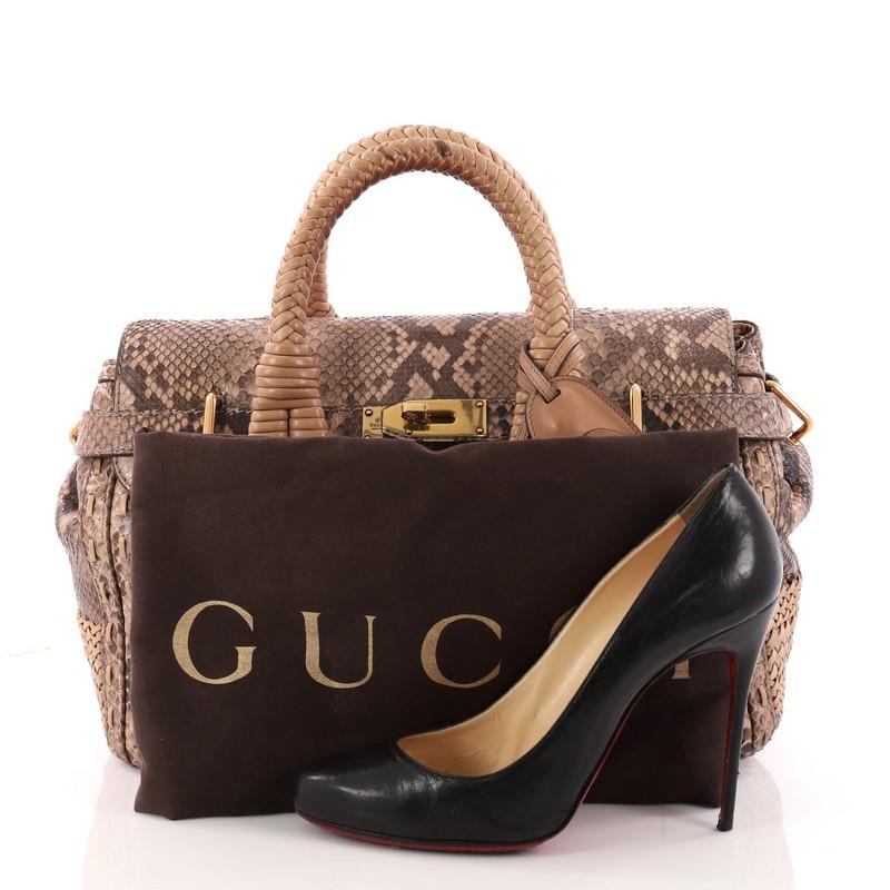 This authentic Gucci Handmade Satchel Python Medium is perfect for a weekend getaway. Crafted in genuine python with woven details, this bag features dual woven-braided handles, gold-tone hardware accents, a delicate handmade design, protective base