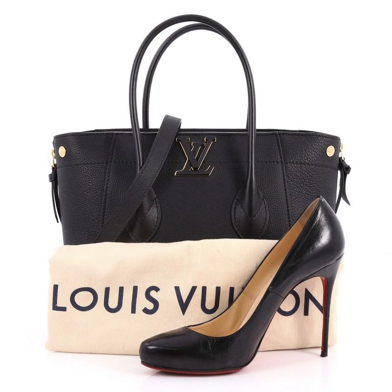 This authentic Louis Vuitton Freedom Handbag Calfskin is a stylish bag perfect for your day or evening looks. Crafted in black calfskin leather, this bag features dual-rolled leather handles, detachable strap, cut out leather LV logo on the top