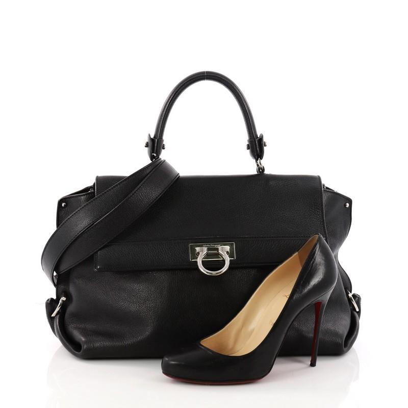 This authentic Salvatore Ferragamo Sofia Satchel Grainy Leather Large is a stylish and functional, chic bag perfect for the modern woman. Crafted in black grainy leather, this bag features rolled leather handle, protective base studs, exterior back