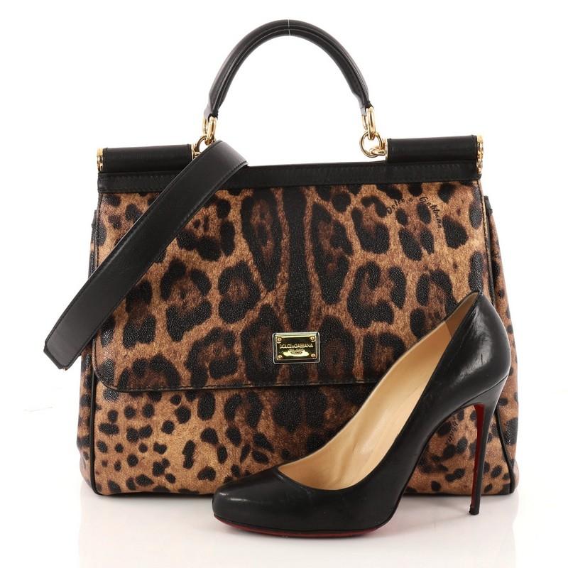 This authentic Dolce & Gabbana Miss Sicily Handbag Leopard Print Leather Large pays homage to the designers' Sicilian heritage with a fresh twist. Crafted from leopard print leather with black leather trims, this bag features leather top handle,