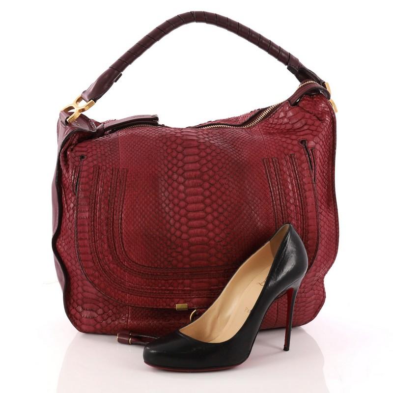 This authentic Chloe Marcie Hobo Python Large showcases the brand's popular horseshoe design in a classic hobo design. Constructed from beautiful burgundy python leather, this functional yet stylish hobo bag features a slouchy, easy-to-carry