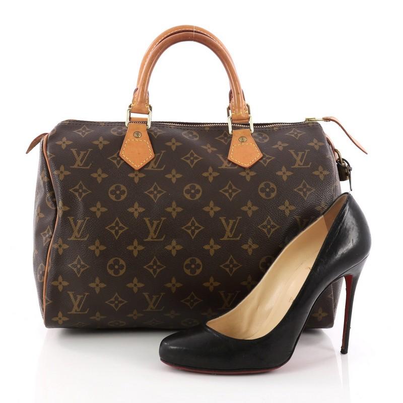 This authentic Louis Vuitton Speedy Handbag Monogram Canvas 30 is spacious and light, making it ideal to use everyday. Crafted in brown monogram coated canvas, this iconic Speedy features dual-rolled leather handles, vachetta leather trims, and