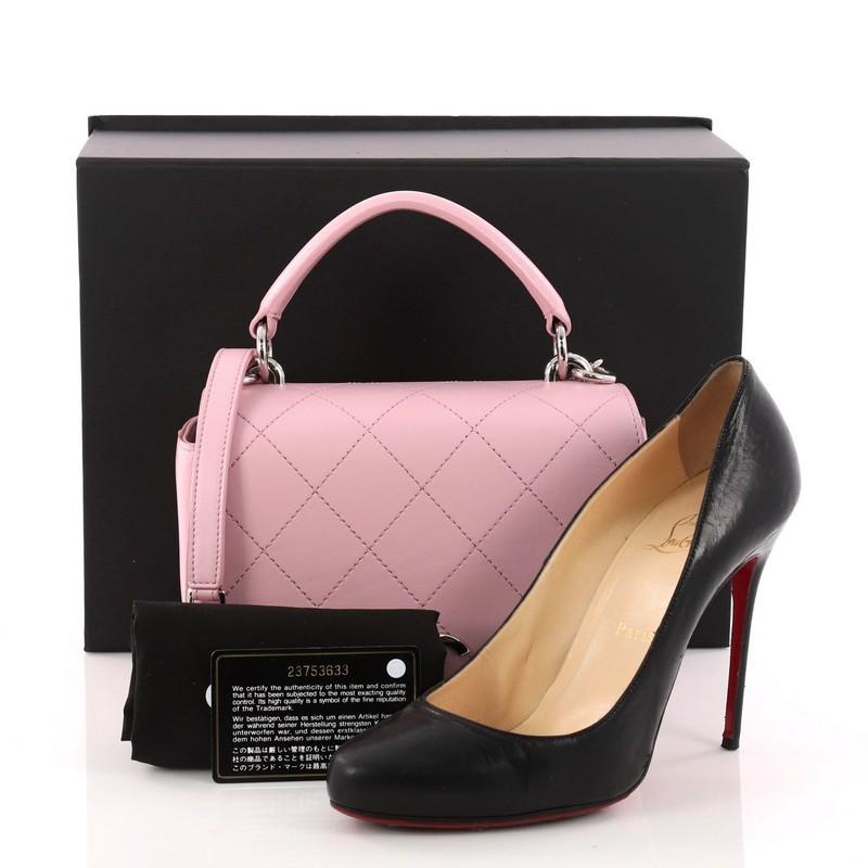 This authentic Chanel Ring My Bag Top Handle Quilted Calfskin Small is ideal for on-the-go woman. Crafted in pink quilted calfskin leather, this bag features leather top handle, woven-in leather chain link strap, exterior zip pocket and silver-tone