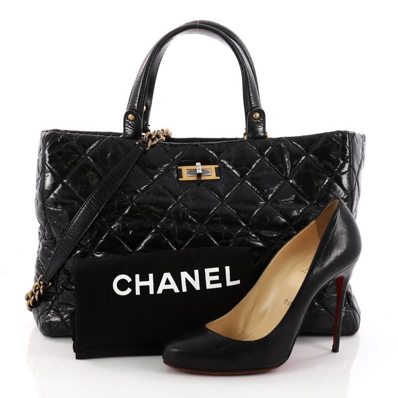 This authentic Chanel Rita Tote Quilted Glazed Crackled Calfskin Small presents a classic and timeless style made for any fashionista. Constructed in luxurious black diamond quilted glazed crackled calfskin leather, this chic tote features dual-flat