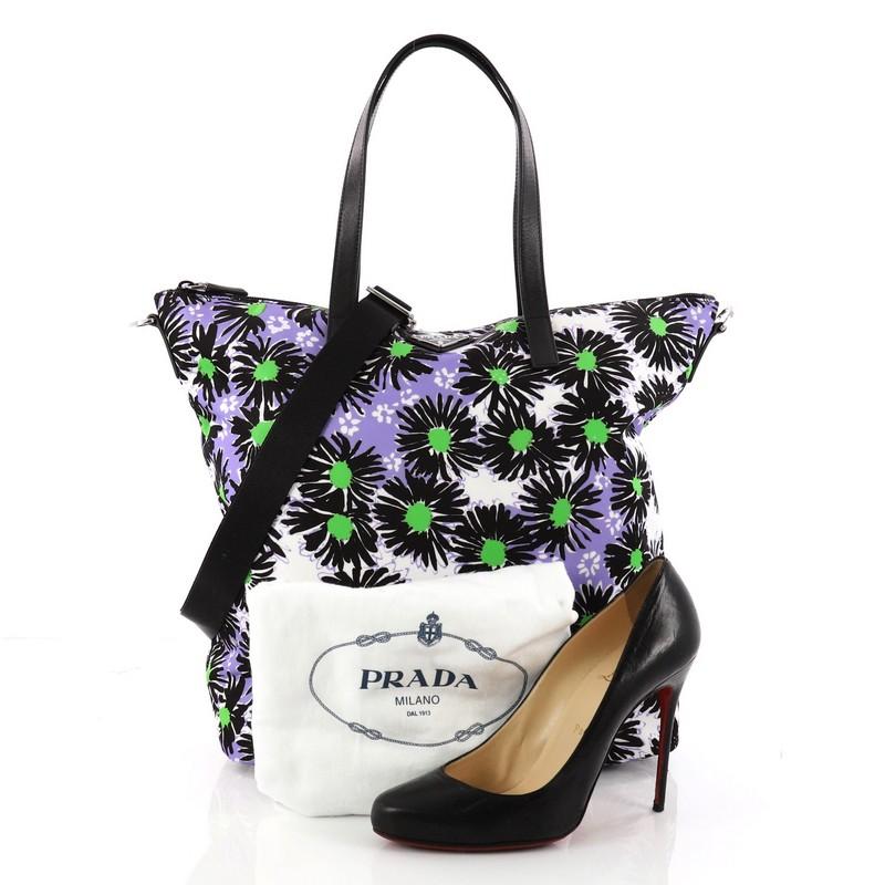 This authentic Prada Convertible Tote Printed Tessuto With Saffiano Large is an eye-catching piece perfect for modern fashionistas. Crafted from multicolored printed tessuto, this tote features a stunning floral print design, dual-top leather
