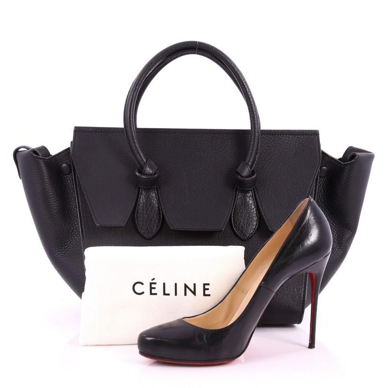 This authentic Celine Tie Knot Tote Grainy Leather Small is an absolute must-have for serious fashionistas. Crafted from black grainy leather, this boxy, chic tote features dual-rolled leather handles with signature knot accents, protective base